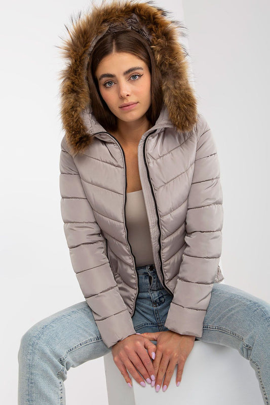 Elegant woman showcasing the luxury 100% polyester jacket with a stylish faux fur hood, perfect for fashionable winter outerwear.