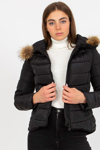 Elegant black polyester puffer jacket with a fur hood, styled on a model in a white turtleneck, perfect for stylish winter outerwear.