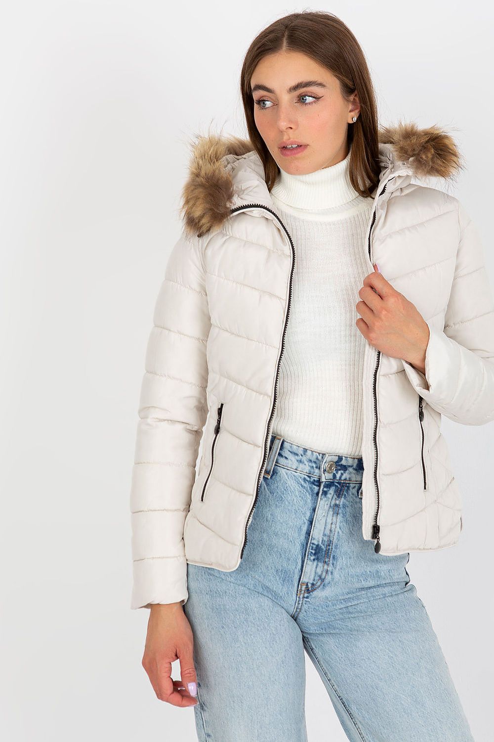 Fashion-forward white puffer jacket with fur-lined hood showcased on a model, paired with vintage blue jeans, ideal for elegant winter fashion.