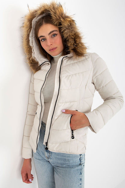 Stylish white puffer jacket with a luxurious fur hood, model presenting an upscale winter outfit with a white turtleneck and blue denim.