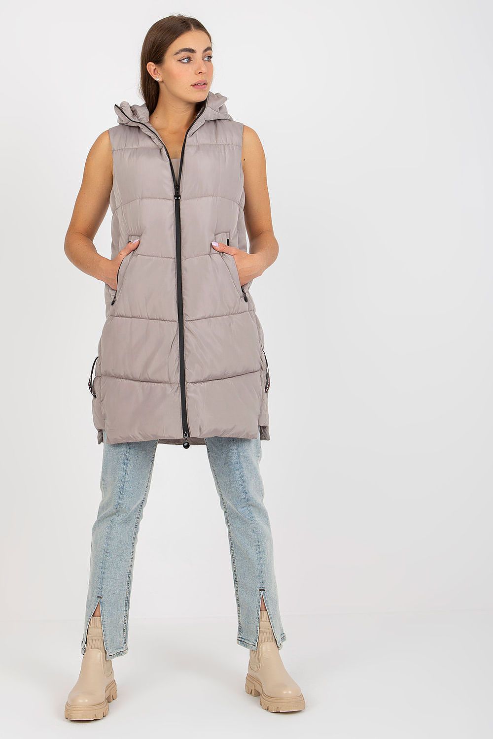 Elegant NM Gilet showcasing a tailored fit in a sophisticated light grey colour, featuring a full zip and hood, styled with relaxed jeans and ankle boots for a chic casual look.
