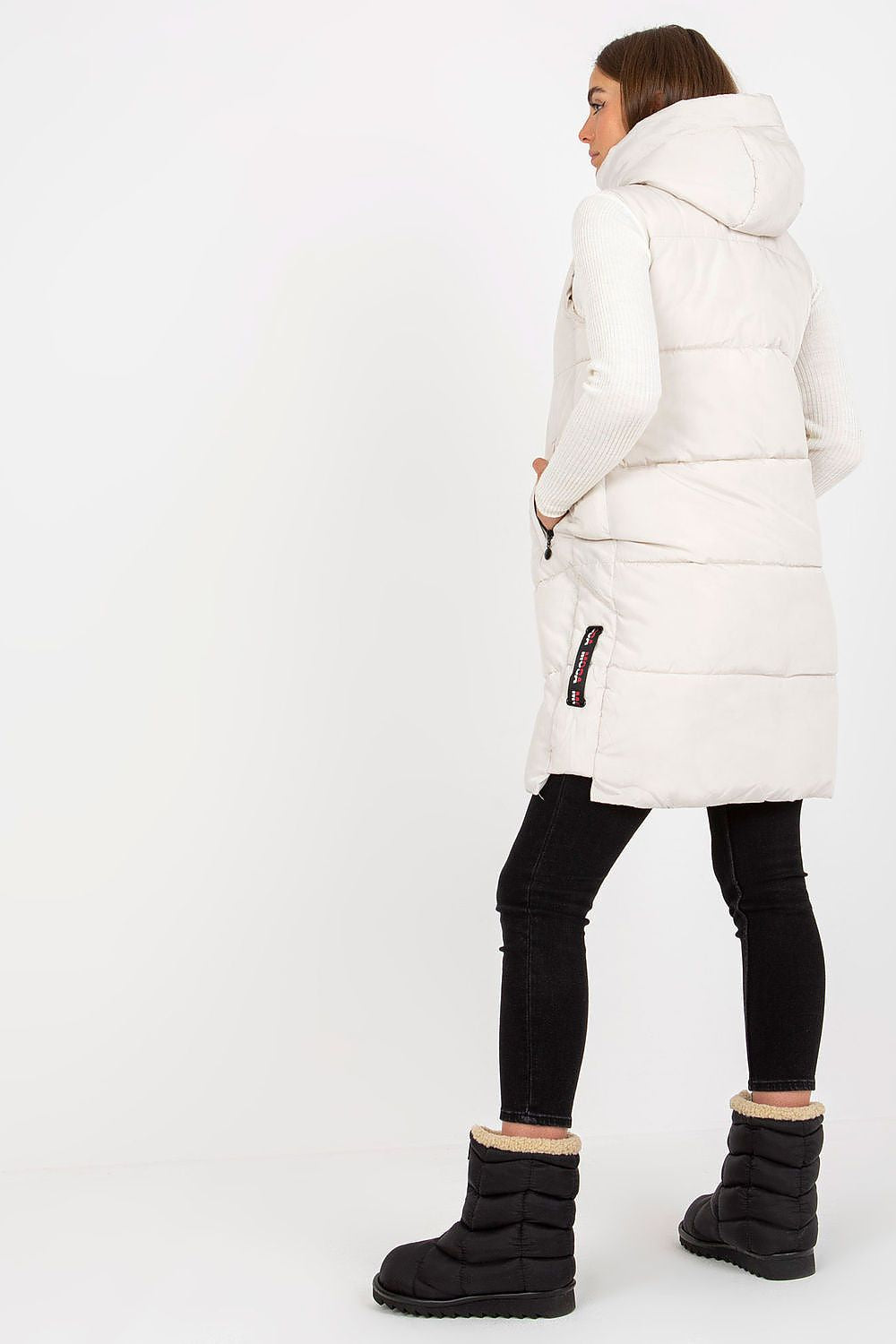 Back view of the Elegant NM Gilet in white, featuring a luxurious design with a focus on its contemporary shape and cohesive style, ideal for chic winter layering.