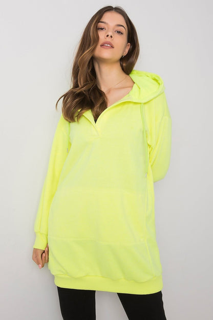 Chic women's neon yellow hooded sweatshirt by Ex Moda, designed with an extended cut and kangaroo pocket, ideal for a stylish casual look.