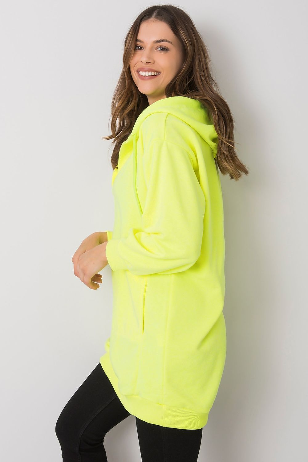 Fashion-forward women's neon yellow hooded sweatshirt from Ex Moda, with a comfy extended cut and kangaroo pocket, an essential for elegant leisurewear.