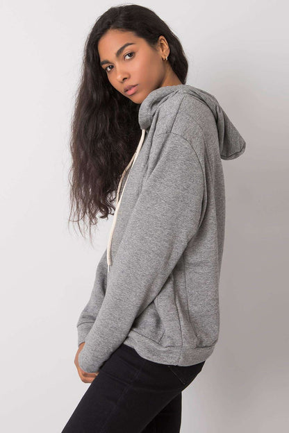 Chic side view of a luxurious women's cotton blend hoodie with long sleeves, showcasing its trendy hood and relaxed fit.