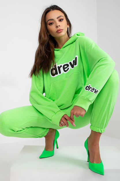 Chic neon green hoodie and jogger pants ensemble, showcasing a modern oversized fit and stylish detailing, paired with striking green high heels for a sophisticated athleisure style.
