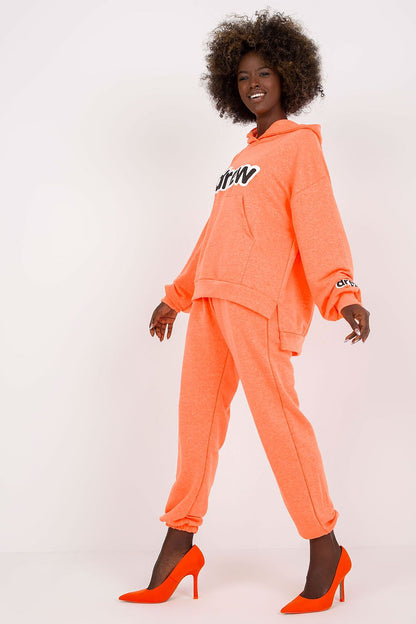 Fashion-forward approach to luxurious loungewear, showcasing an orange cotton blend set designed for comfort and elegance, highlighted by stylish heeled footwear.