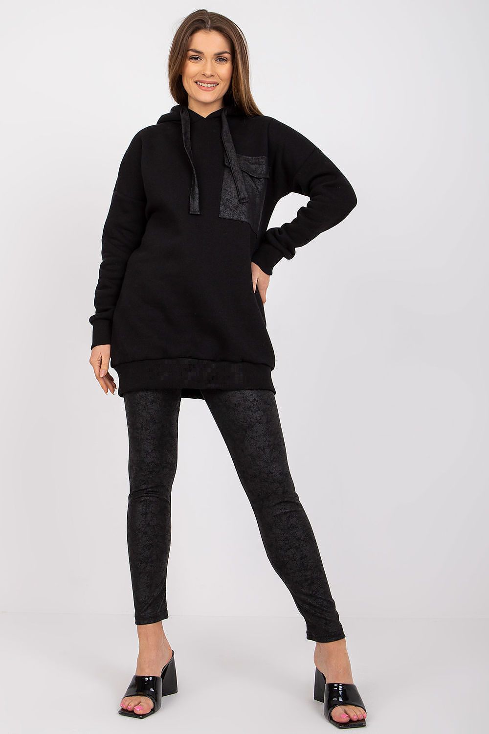 Ex Moda luxury black cotton sweatshirt and leggings set featuring a stylish hood and pocket detail, model posing confidently in high heels.