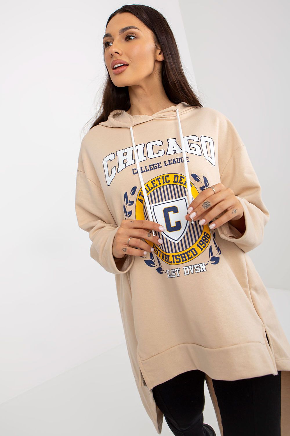 Elegant women's loose asymmetrical hoodie sweatshirt crafted from 100% cotton, featuring long sleeves and a stylish Chicago collegiate graphic. Perfect for a luxurious and relaxed aesthetic.