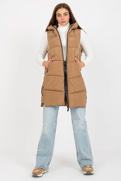 Chic NM Gilet showcased in a premium beige shade, model standing confidently in a tailored sleeveless vest, perfect for an elegant layered look.