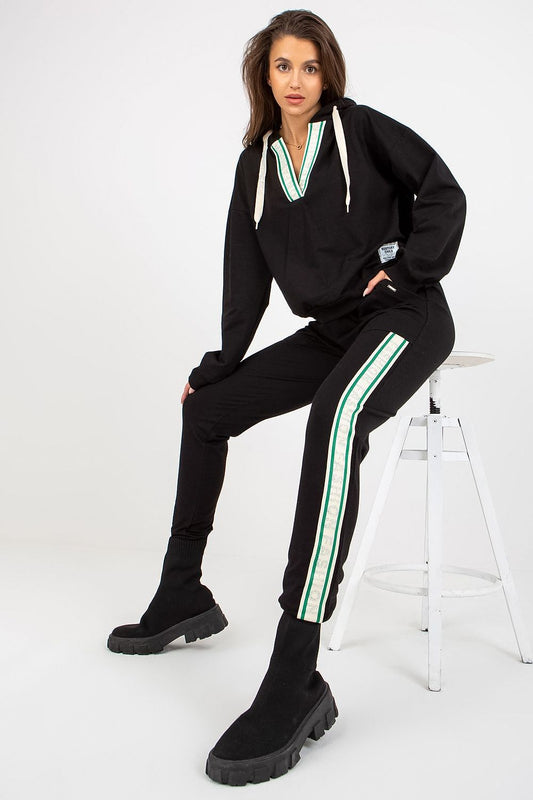 Luxurious black cotton-blend hoodie and long pants set with stylish green striped detail, featuring oversized hoodie design and slip pockets, model showcasing contemporary loungewear style.