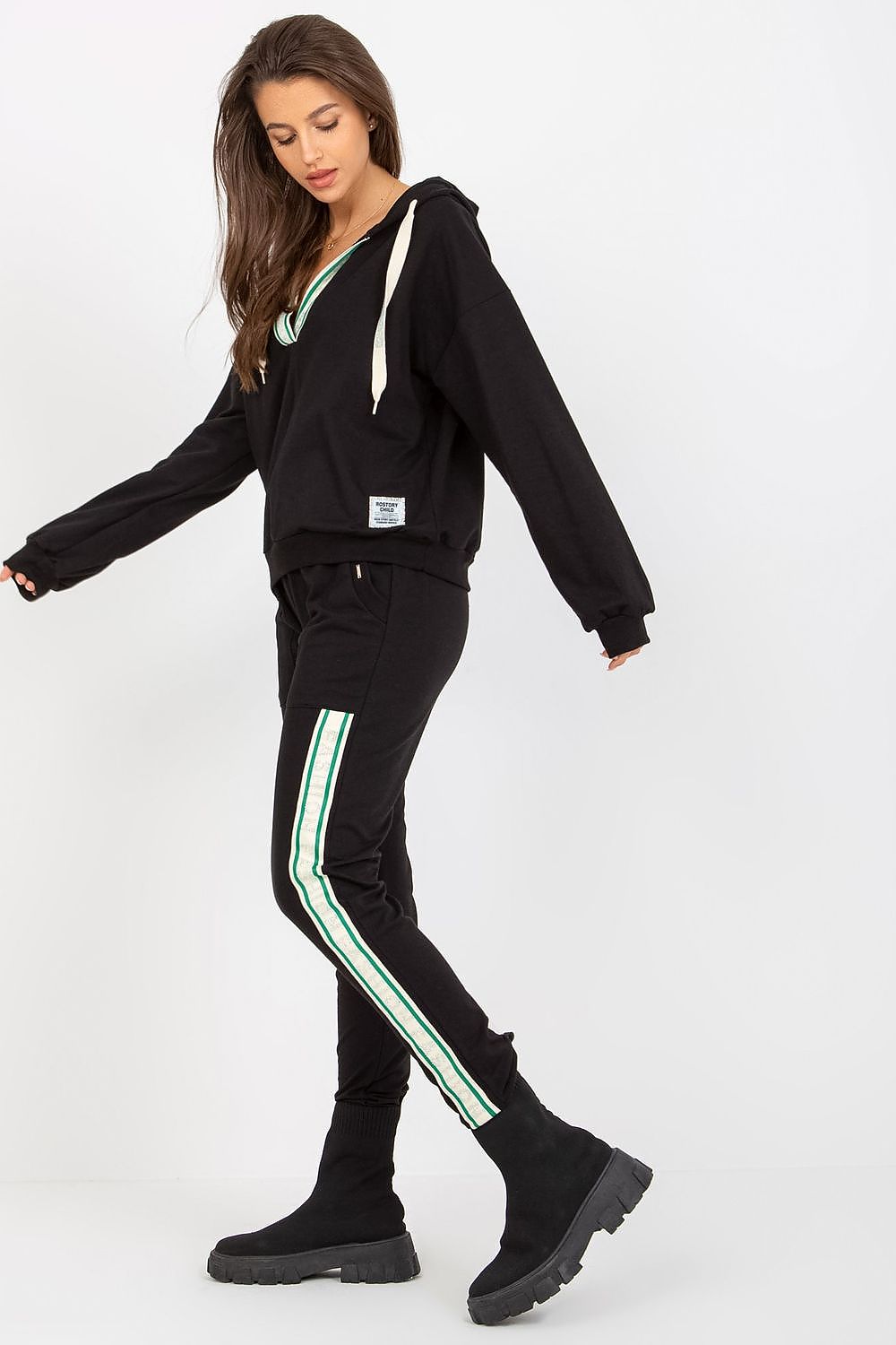 Elegant black cotton-blend sweatshirt and pants ensemble, highlighting a chic hooded sweatshirt and stylish tapered pants with green accent stripes, perfect for sophisticated leisure.