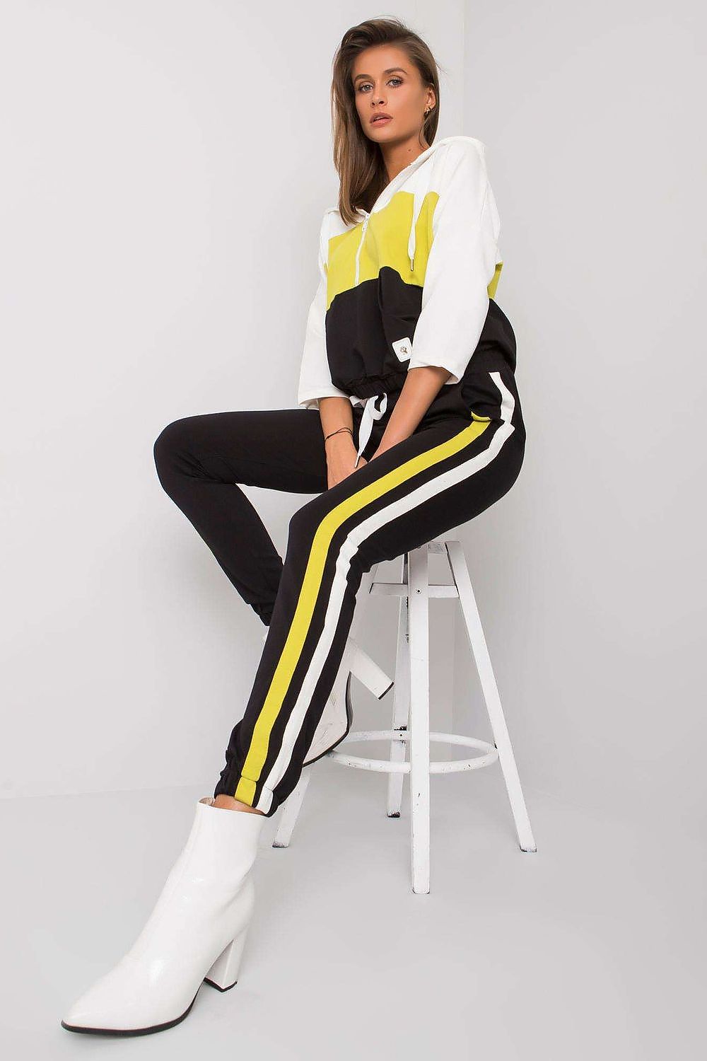Chic black and yellow women's cotton sweatshirt set with a luxurious vibe, featuring a hood and long pants, offering a contemporary look for any occasion.