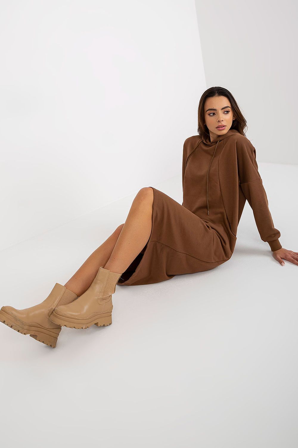 Chic brown sweat dress with a contemporary silhouette, complete with a hood and slip pockets, ideal for effortless elegance.