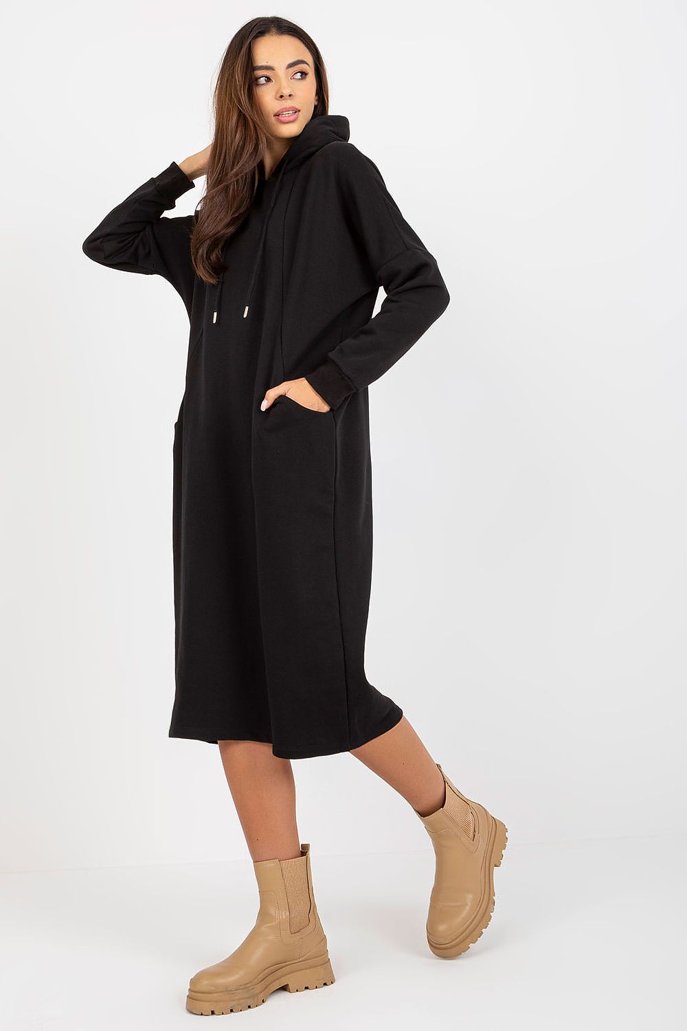 Chic black cotton spandex sweat dress with hood, elegantly designed for a luxurious look, complemented by trendy tan ankle boots.
