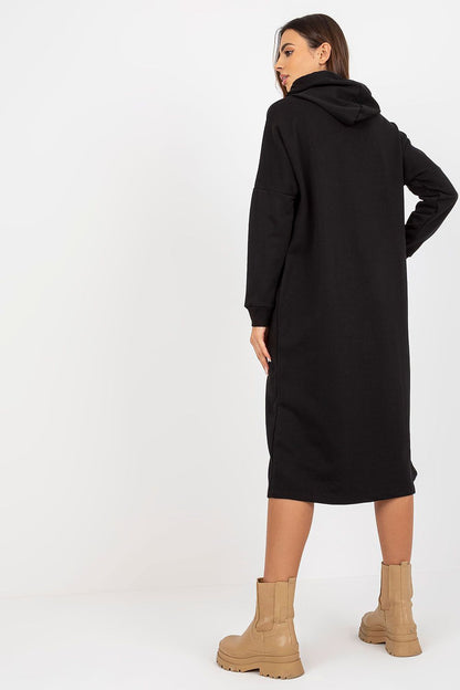 Back view of a sophisticated black cotton spandex sweat dress with hood, reflecting comfort and style, paired with fashionable tan boots for a luxurious outfit.