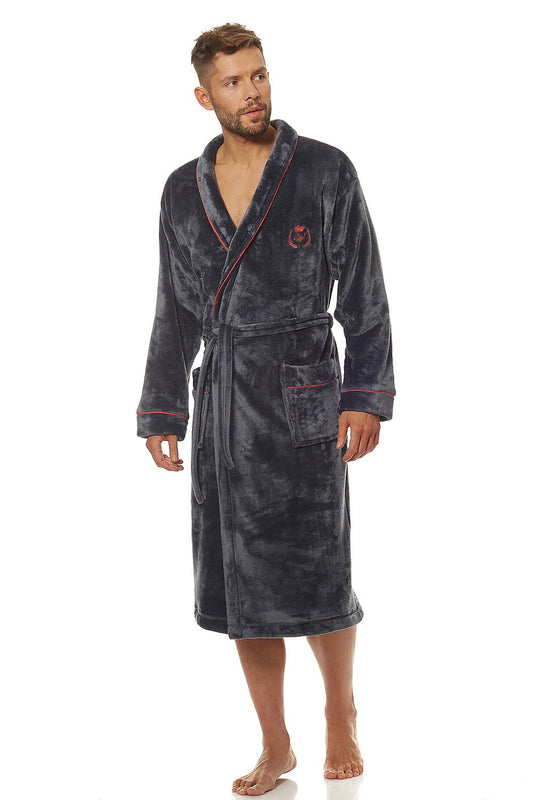 Luxury classic men's bathrobe in soft knit fabric, featuring a stylish design with a shawl collar, external pockets, and a tied waist, modelled by a man, showcasing elegance and comfort.