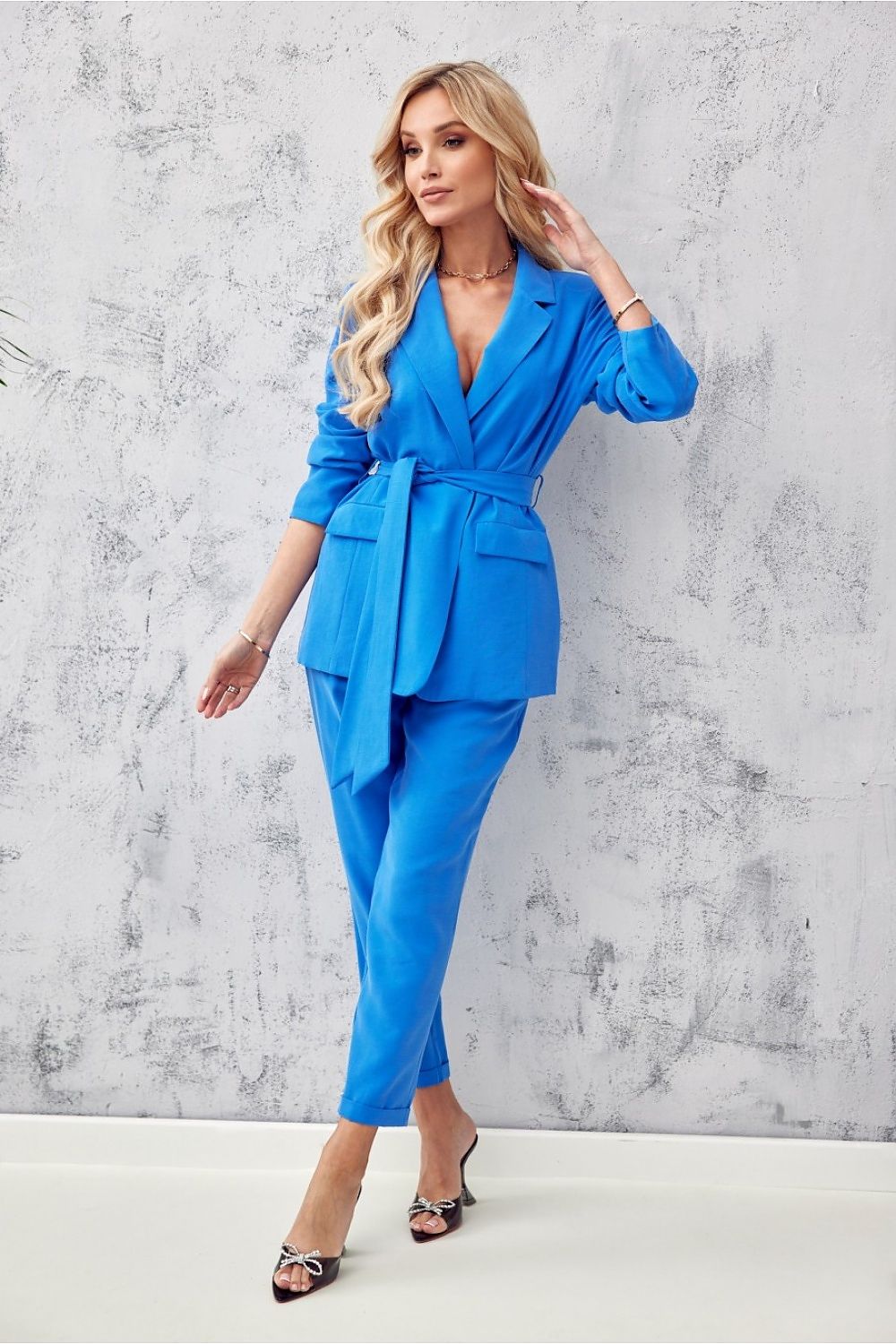 Elegant women's blazer with waist belt by Roco Fashion, crafted from premium soft fabric. This stylish jacket features decorative pocket patches and shoulder cushions, perfect for both elegant and sporty outfits.