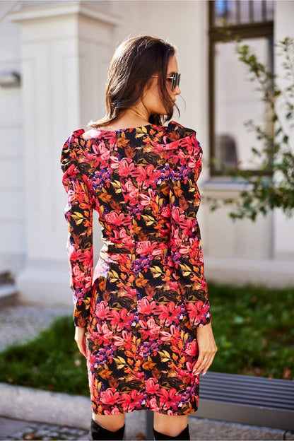 Elegant back view of a convertible mini dress with buff sleeves in a vibrant floral pattern, showcasing its sophisticated envelope neckline and flattering silhouette, ideal for both casual and evening wear.