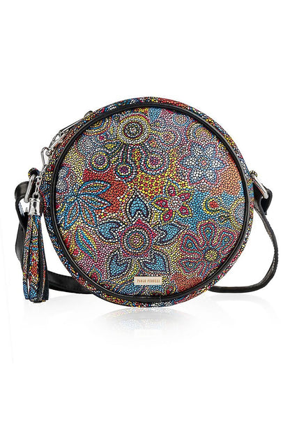 Chic round women's handbag in vibrant floral design, showcasing a blend of colourful patterns with a sleek black leather strap, perfect for sophisticated styling and everyday elegance.