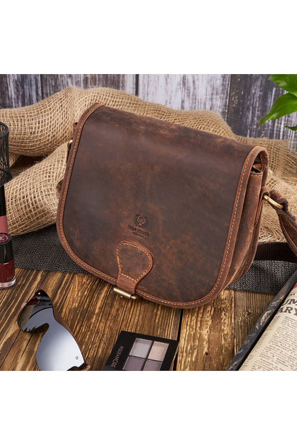 Stylish vintage women's handbag displayed with cosmetic items and sunglasses, epitomising luxury and functionality in a rich brown leather finish.