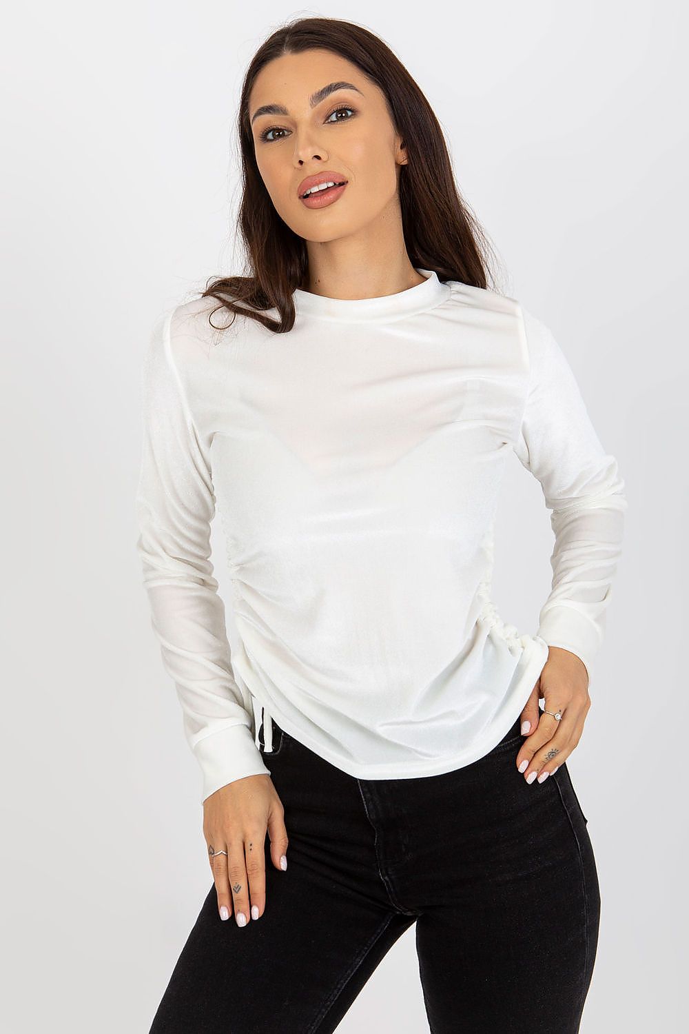 Glamorous white velour blouse with long sleeves, featuring adjustable ties, modelled elegantly, perfect for enhancing a luxurious wardrobe.