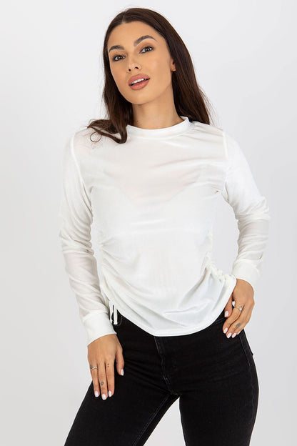 Glamorous white velour blouse with long sleeves, featuring adjustable ties, modelled elegantly, perfect for enhancing a luxurious wardrobe.