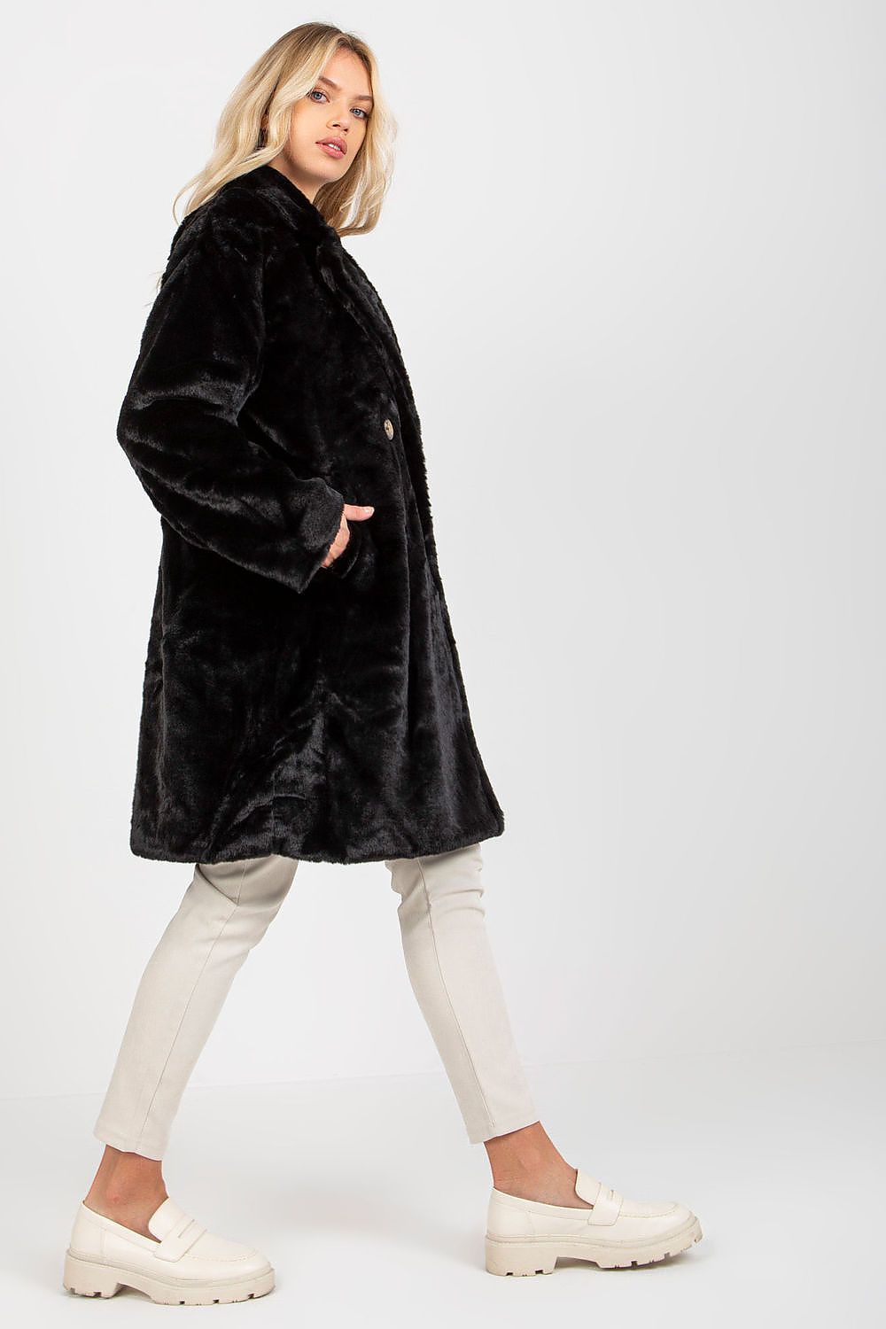 Luxury black long sleeve fur coat from Och Bella, featuring a fully lined design, slip pockets, and elegant buttoned front, modelled in a stylish pose.