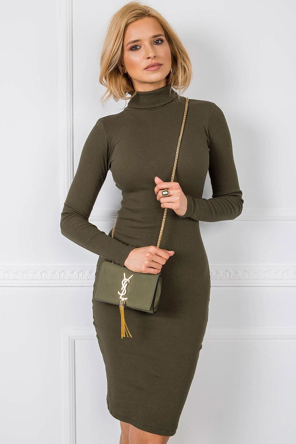 Stylish olive green fitted long sleeve turtleneck dress by Rue Paris, paired with a chic gold chain bag, exuding refined elegance.