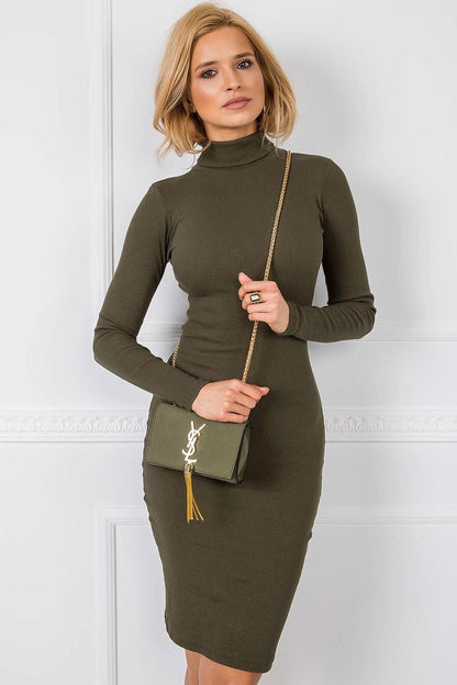 Stylish olive green fitted long sleeve turtleneck dress by Rue Paris, paired with a chic gold chain bag, exuding refined elegance.