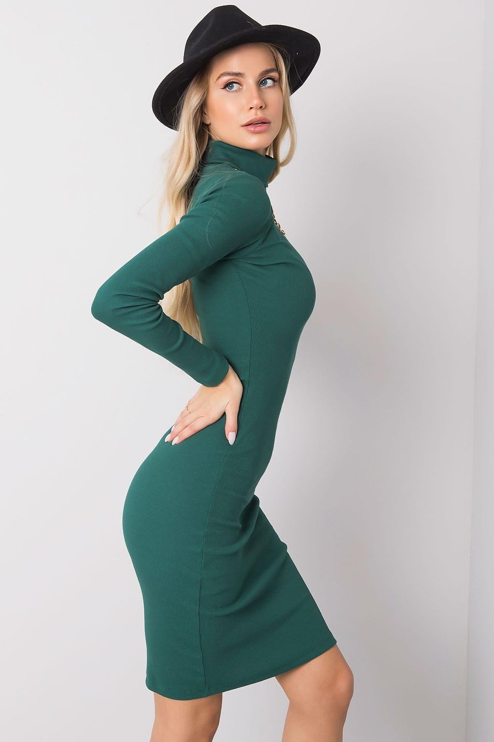 Chic profile view of a fitted long sleeve turtleneck dress in green, highlighting its flattering silhouette and modern style.