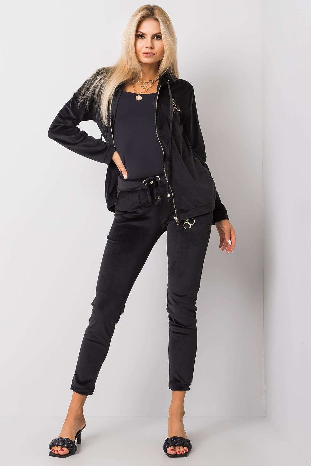 Luxurious black velour two-piece set featuring a hooded zip-up sweatshirt and matching tie-waist pants, styled for elegance.