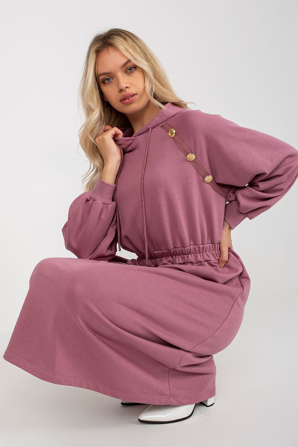 Luxurious casual cotton hoodie dress in soft mauve with long sleeves, featuring decorative buttons and an elastic waist, styled elegantly for a chic everyday look.