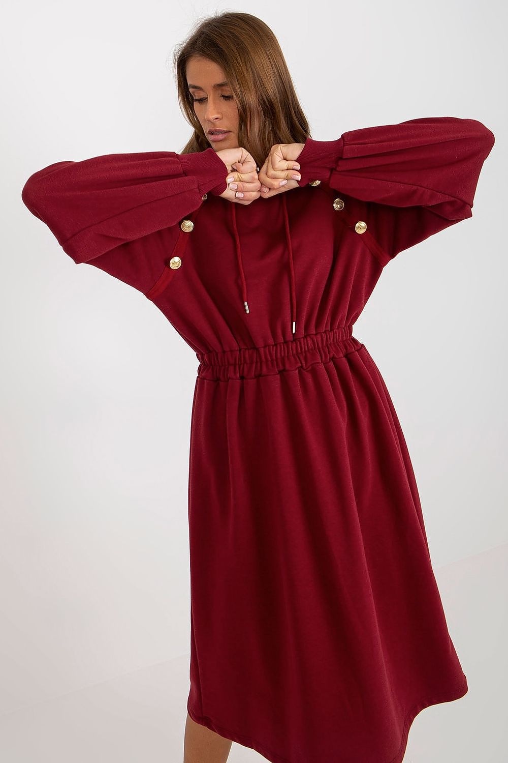 Chic burgundy hoodie dress with decorative buttons, showcasing long puff sleeves and a cinched waist, designed for a sophisticated casual look.