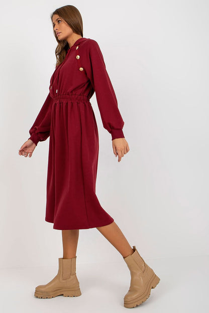 Fashionable burgundy hoodie dress styled elegantly with long sleeves and a belted waist, perfect for elevating casual attire.