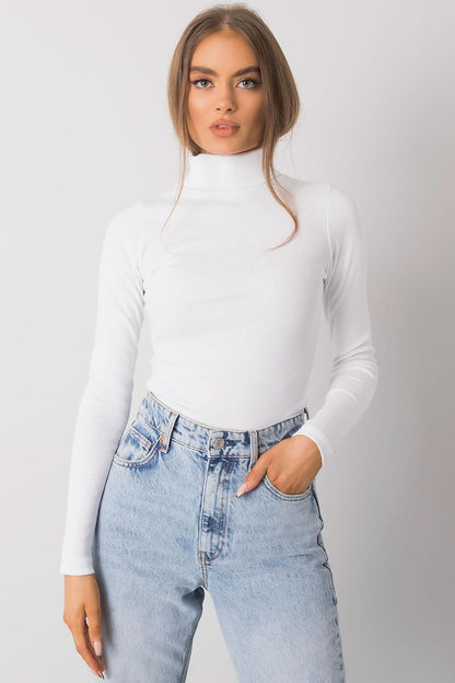 Luxurious white fitted turtleneck, with long sleeves and a high neck, paired with light blue high-waisted jeans for a chic ensemble.