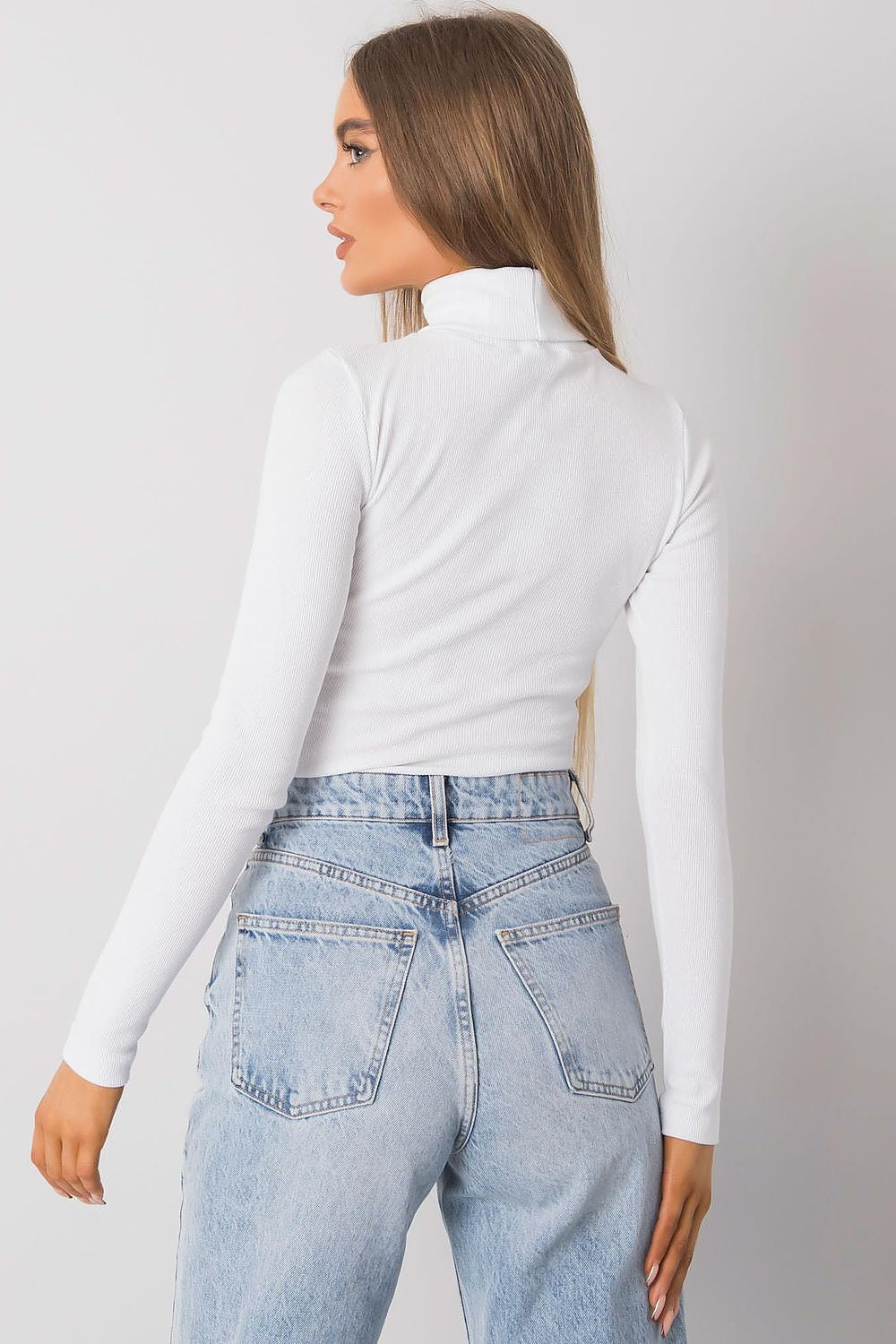 Chic rear view of a fitted white cotton turtleneck paired with light blue denim, highlighting the sophisticated design ideal for upscale casual wear.