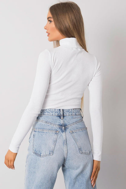 Chic rear view of a fitted white cotton turtleneck paired with light blue denim, highlighting the sophisticated design ideal for upscale casual wear.