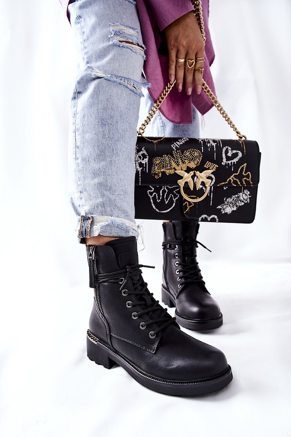 Elegant black ecological leather worker boots featuring dual zippers, paired with casual ripped denim, showcasing a chic and modern style.