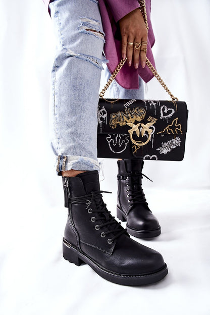 Elegant black ecological leather worker boots featuring dual zippers, paired with casual ripped denim, showcasing a chic and modern style.