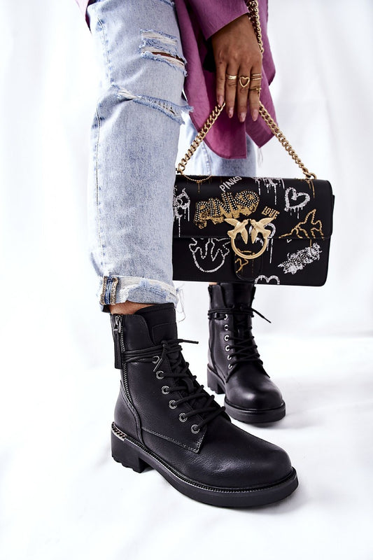 Elegant black ecological leather worker boots featuring dual zippers, paired with casual ripped denim, showcasing a chic and modern style.