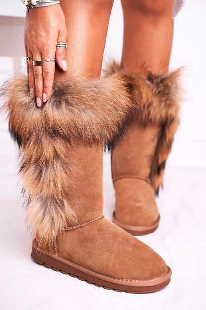 Luxurious suede leather snow boots featuring warm fur lining and elegant fluffy detailing, perfect for winter style and comfort. Styled with a fashionable touch, showcasing an exquisite blend of warmth and sophistication.