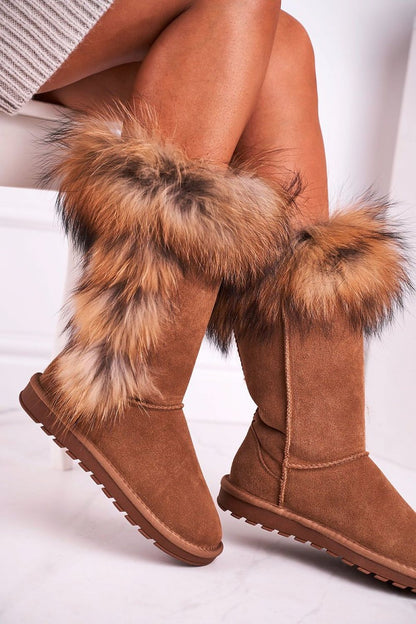 High-quality luxury suede leather snow boots featuring a warm fur lining and elegant fluffy detailing, perfect for winter fashion. The boots showcase a stylish calf-high design, ideal for cold weather.