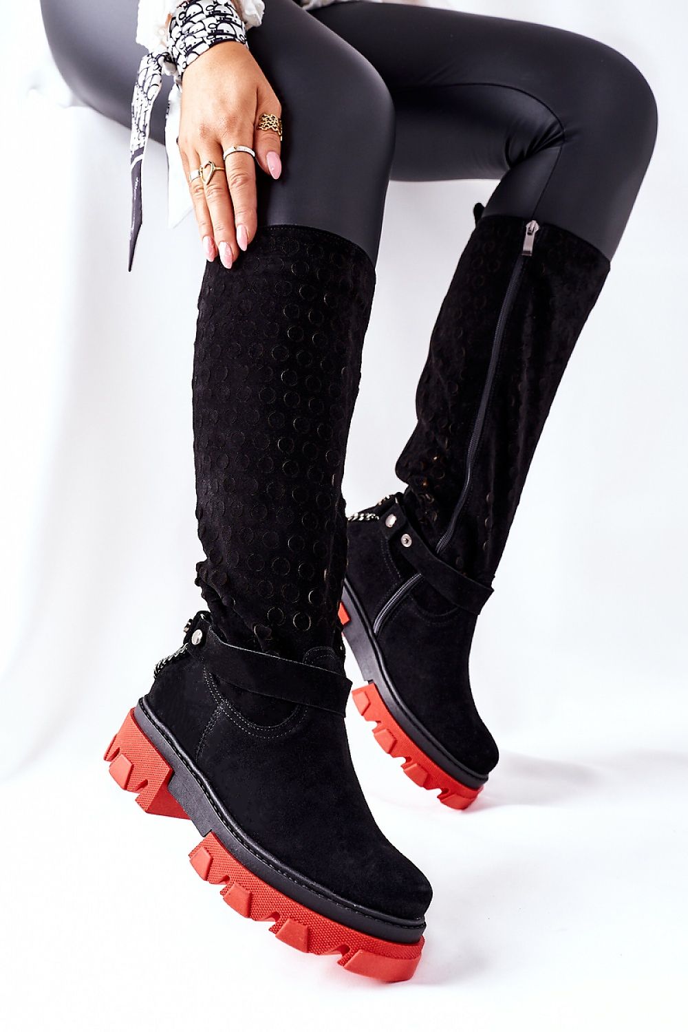 Stylish black suede thigh-high boots featuring a thick platform sole, complemented by a detachable chain embellishment, showcased against a white backdrop for an elegant luxury vibe.
