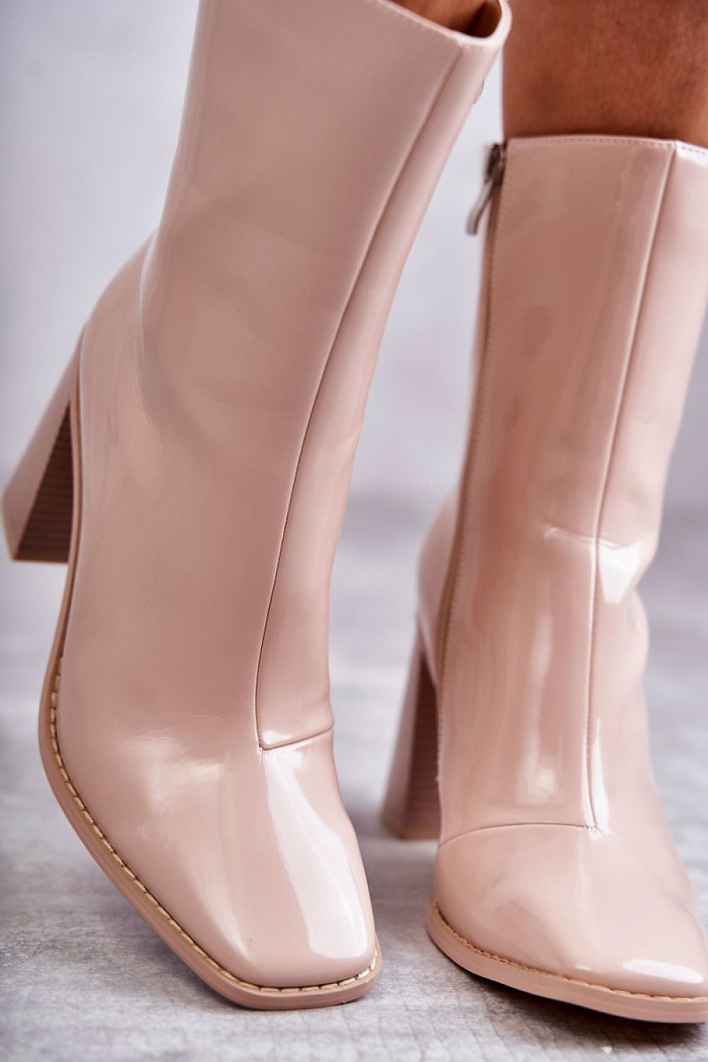 Luxurious eco leather knee-high boots in a soft nude hue, showcasing a fashionable stiletto heel and a side zipper for ease, perfect for elevating any outfit.