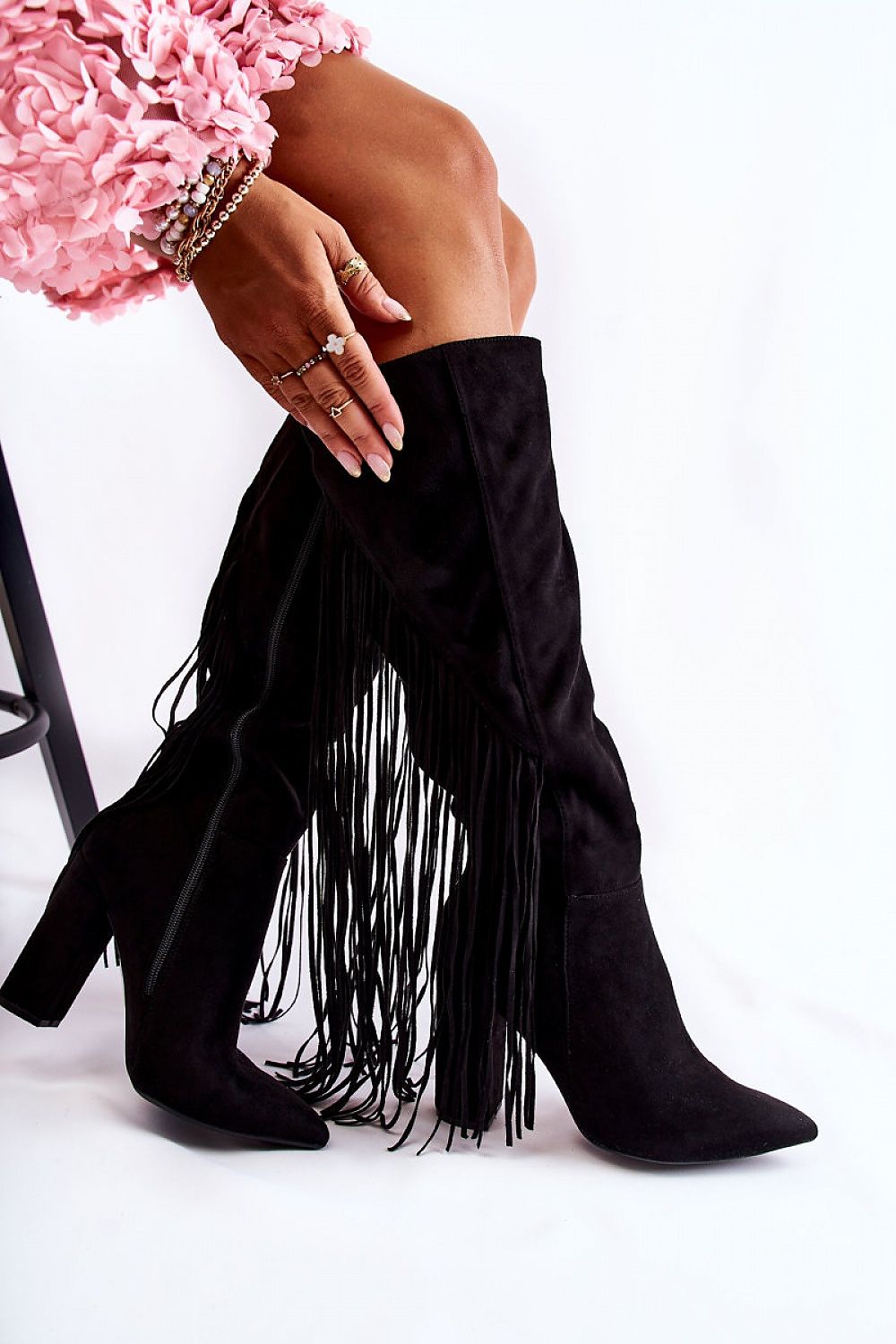 Elegant eco-suede heel boots with pointed toe and tassels, showcasing a sleek design and 10.5 cm heel height, styled alongside chic accessories.