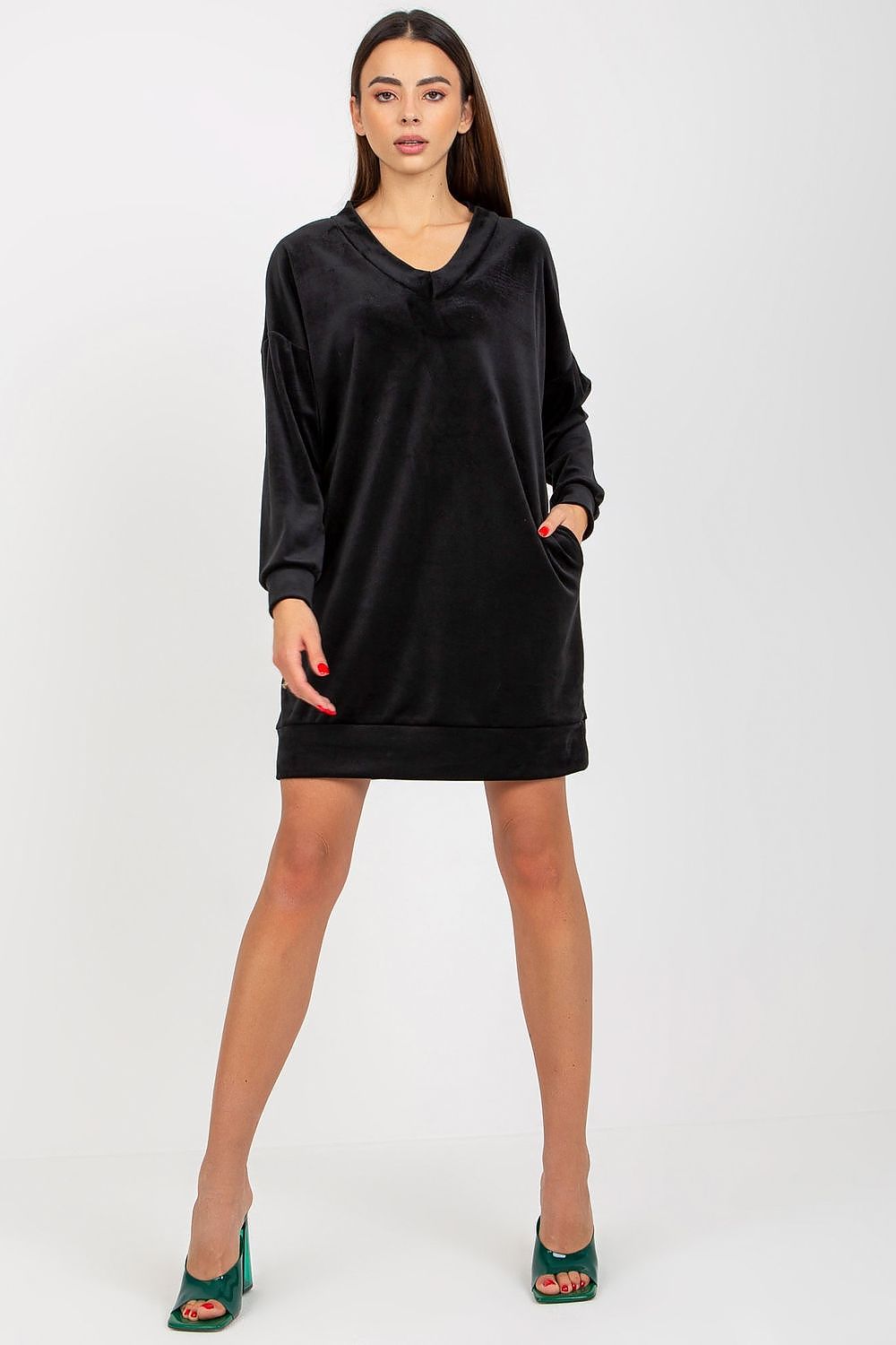 Elegant black velour dress with long sleeves and a heart neckline, designed for versatile everyday wear, showcased by a poised model in stylish green heels.