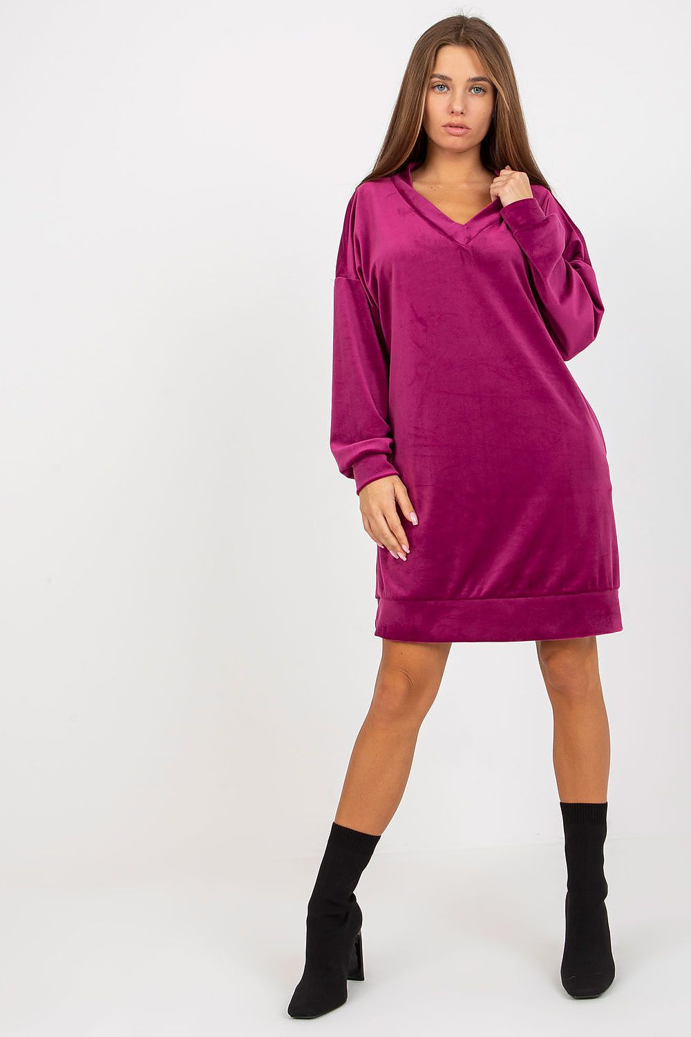 Vibrant magenta velour dress with long sleeves and a heart neckline, paired with ankle boots for a trendy, luxurious look.