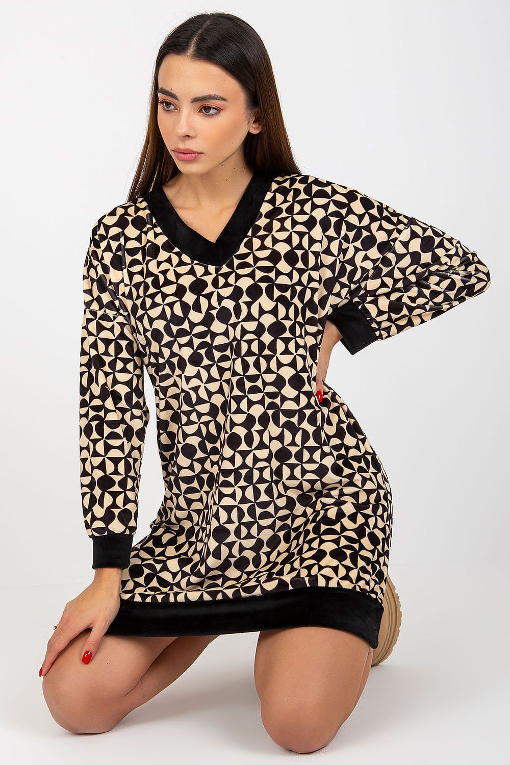 Stylish short velour dress with a unique geometric pattern in cream and black, designed with a v-neckline and long sleeves for a modern touch.