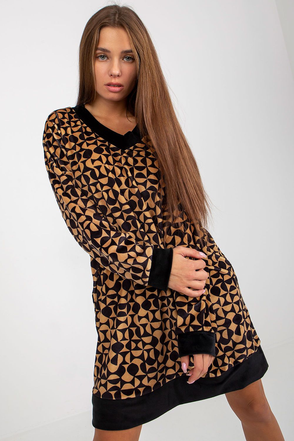 Chic short velour dress featuring a modern geometric pattern, complemented by a v-neck and contrast cuffs, offering a luxurious everyday look.